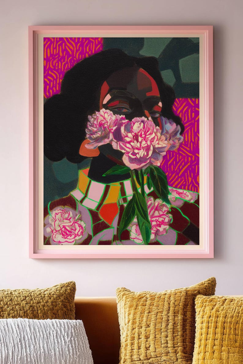 May include: A framed art print featuring a stylized portrait of a person with dark skin, obscured by a cluster of pink peonies. The background displays vibrant magenta and orange patterns, while the person wears a checkered collar and floral garment.