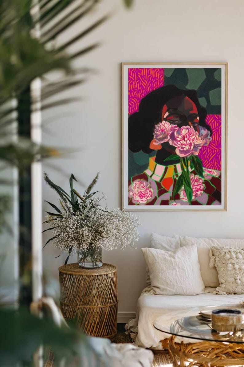 May include: A framed rectangular art print featuring a stylized portrait of a person with dark skin and hair, holding pink peony flowers over their face. The background consists of vibrant magenta and dark green geometric patterns.