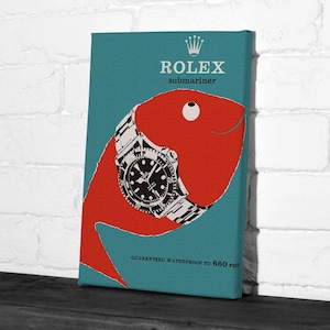 May include: A canvas print featuring a red fish design with a Rolex Submariner watch. The watch has a black face and silver band. The background is teal with the words "ROLEX Submariner" and "GUARANTEED WATERPROOF TO 660 FEET".