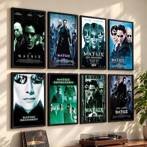 May include: Eight framed movie posters from The Matrix franchise arranged in two rows on a wall. The posters feature various character portraits, scenes, and titles including The Matrix, The Matrix Reloaded, and The Matrix Revolutions in black frames.
