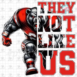 May include: An illustration of a muscular bear in a red and white football uniform, with the text "THEY NOT LIKE US" in red block letters. The bear has a fierce expression and is in a dynamic pose, suggesting action and strength.