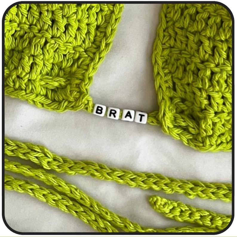 May include: A lime green crocheted top with a lime green crocheted strap. The strap has the word "BRAT" spelled out in white letter beads.