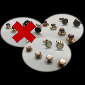 May include: A collection of cufflinks and shirt studs in silver with black and white accents. The cufflinks have a variety of designs, including round, square, and oval shapes. The shirt studs are all round and have a simple design.
