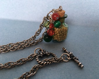 Handcrafted teeny tiny glass jar with cork lid filled with mustard seeds and embellished with beads Italian colors