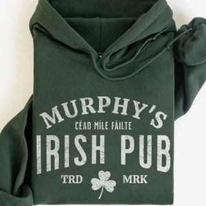 May include: Forest green hooded sweatshirt with the text "Murphy's Irish Pub" in white, with the words "Cead Mile Failte" and "TRD" and "MRK" in smaller white text.