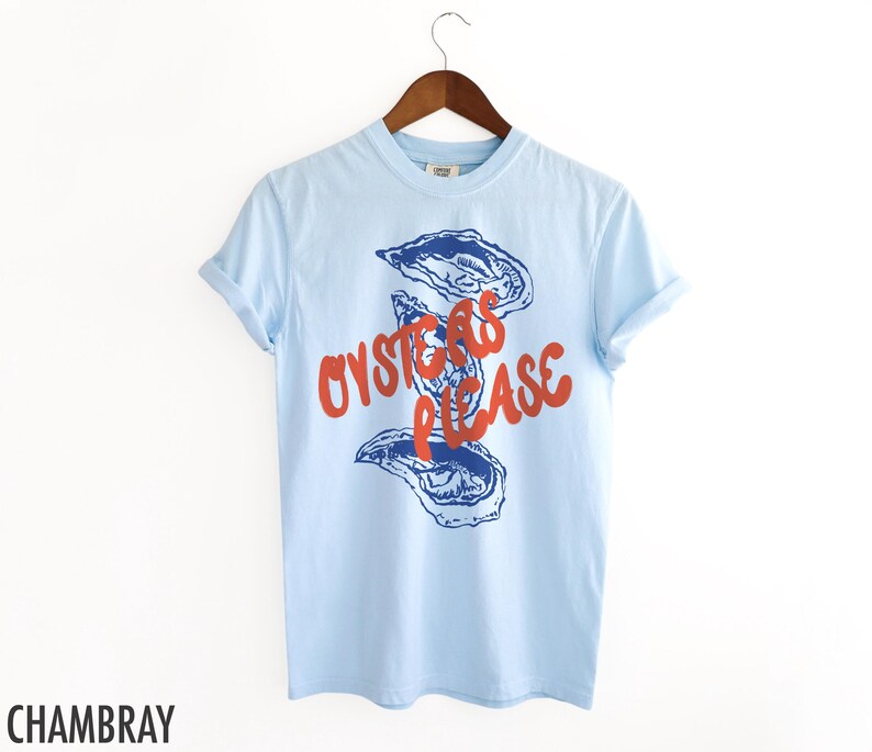May include: A light blue t-shirt with a graphic of oysters and the text "Oysters Please" in red.