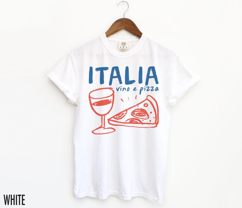 K&ouml;nnte beinhalten: Wei&szlig;es T-Shirt mit einem blauen und roten Grafikdesign, auf dem "ITALIA vino e pizza" mit einem Glas Wein und einem St&uuml;ck Pizza steht.