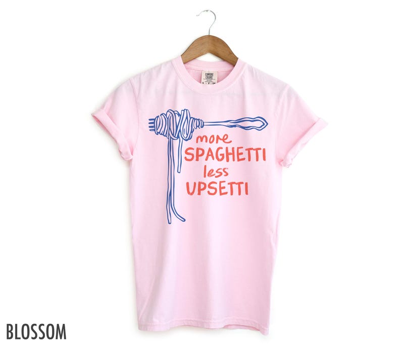 May include: Pink t-shirt with a blue and red graphic of spaghetti and the text "more spaghetti less upsetti"
