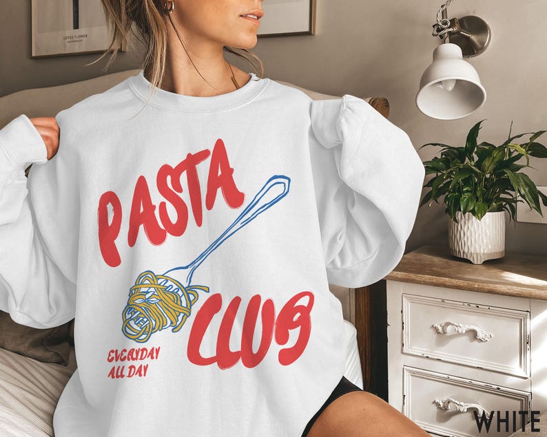 May include: White sweatshirt with a red and blue graphic that says "PASTA CLUB" with a drawing of a fork and noodles. The text "EVERYDAY ALL DAY" is also on the sweatshirt.