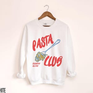 May include: White long-sleeve sweatshirt with a red and blue graphic design that says "PASTA CLUB" with a fork and noodles. The text "EVERYDAY ALL DAY" is below the graphic.