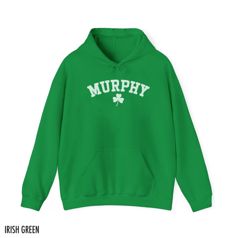 May include: A green hooded sweatshirt with the word "MURPHY" in white lettering and a white shamrock underneath. The sweatshirt is a classic style with a kangaroo pocket.