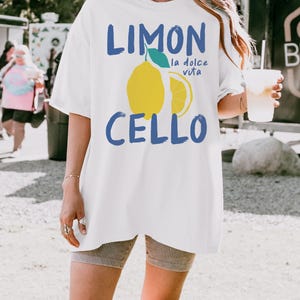 May include: White oversized t-shirt with a blue graphic of a lemon and the text "Limon Cello la dolce vita".