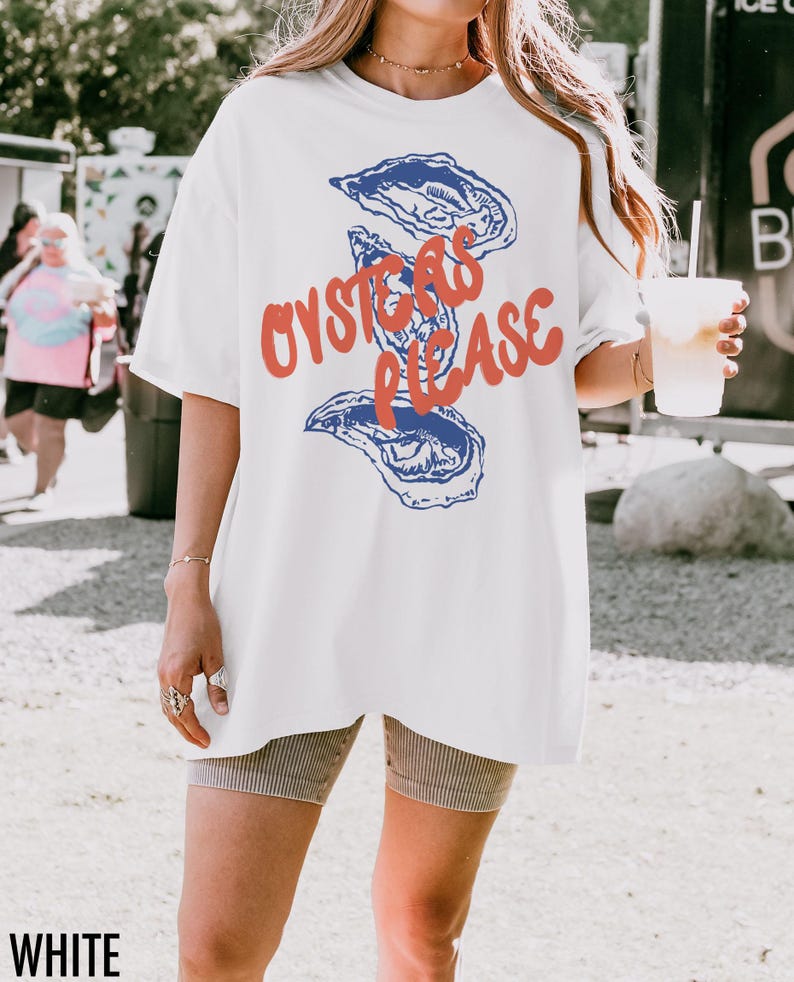 May include: White oversized t-shirt with a graphic of blue oysters and the text "Oysters Please" in red.