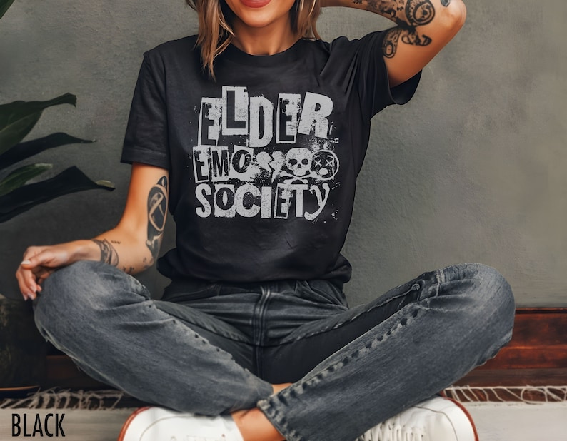 May include: A black t-shirt with a white graphic print that says "Elder Emo Society" with a skull and crossbones design.