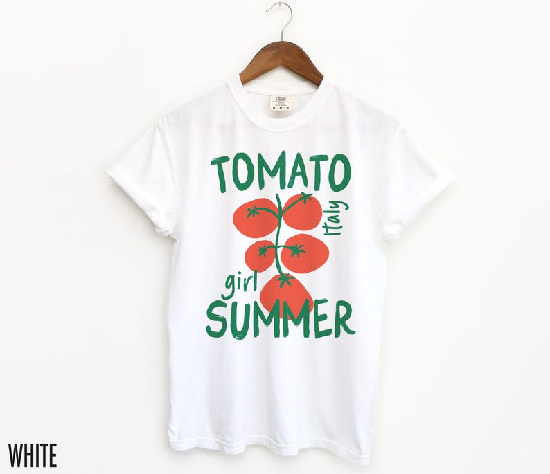 May include: White t-shirt with a green and red tomato graphic and the text "Tomato girl summer Italy".