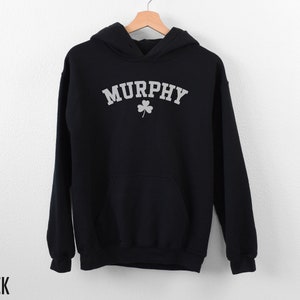 May include: Black hooded sweatshirt with the word "MURPHY" in white text with a shamrock underneath.
