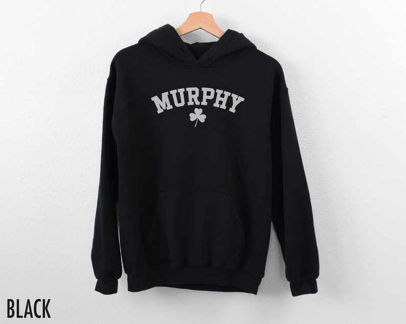 May include: Black hooded sweatshirt with the word "MURPHY" in white text with a shamrock underneath.