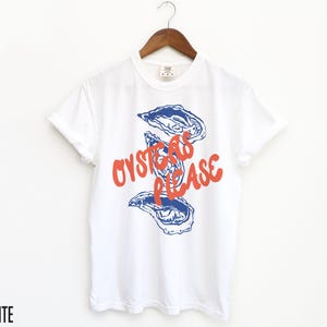 May include: White t-shirt with a blue and red graphic of oysters and the text "Oysters Please".