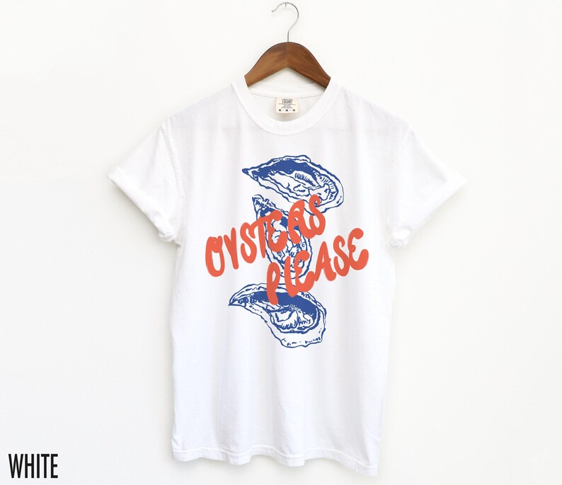 May include: White t-shirt with a blue and red graphic of oysters and the text "Oysters Please".