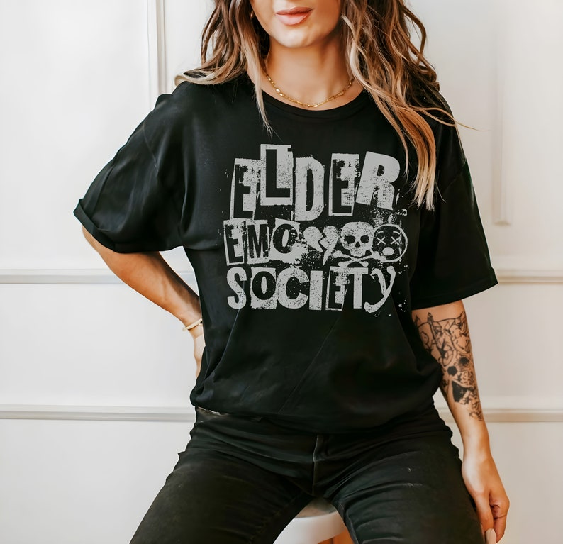 May include: Black t-shirt with a white graphic print that says "Elder Emo Society" with a skull and crossbones design.