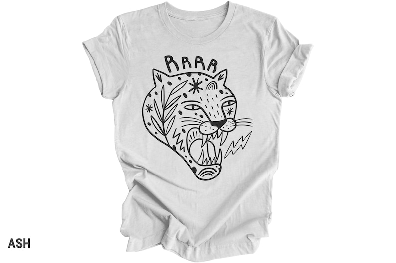 May include: A white t-shirt with a black and white illustration of a roaring tiger with the word "RAWR" above it.