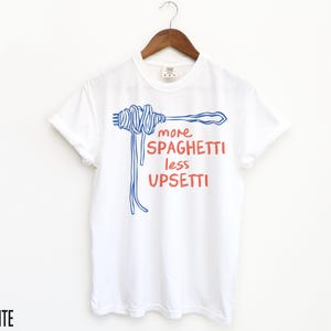 May include: White t-shirt with a blue and red graphic of a fork and spaghetti with the text "more spaghetti less upsetti".