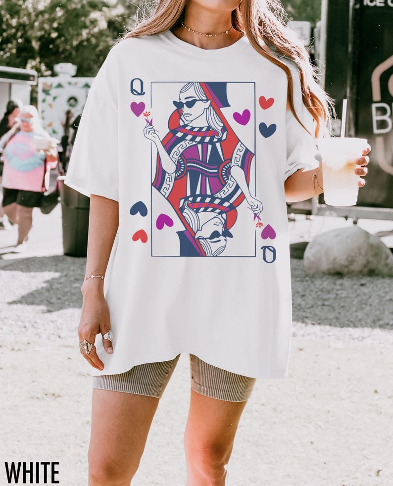 May include: White oversized t-shirt with a graphic print of the Queen of Hearts playing card. The Queen is wearing sunglasses and holding a flower. The card is surrounded by hearts.