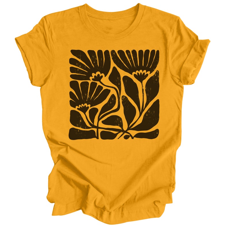 May include: A yellow t-shirt with a black floral print. The print features stylized flowers and leaves.