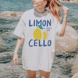 May include: White t-shirt with a graphic of a lemon and the text "Limon Cello" and "la dolce vita".