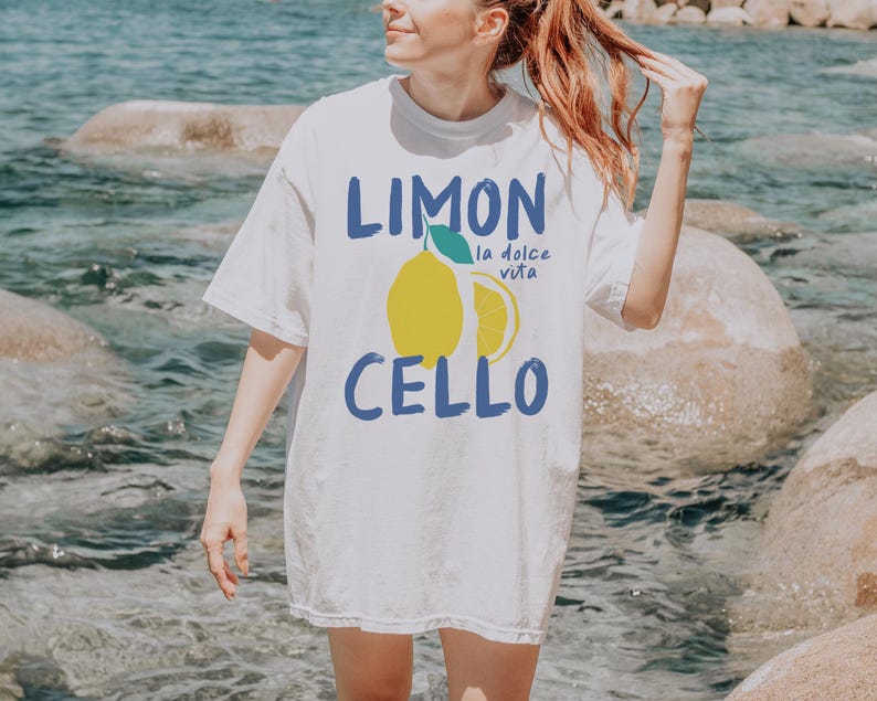 May include: White t-shirt with a graphic of a lemon and the text "Limon Cello" and "la dolce vita".