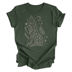 May include: A dark green t-shirt with a white outline of a howling wolf with intricate patterns and symbols. The wolf is surrounded by small floral designs.