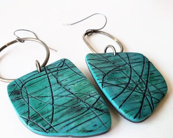 Unique handmade jewelry: teal-black polymer clay and  durable steel, sterling silver findings—a harmonious blend of strength and elegance.