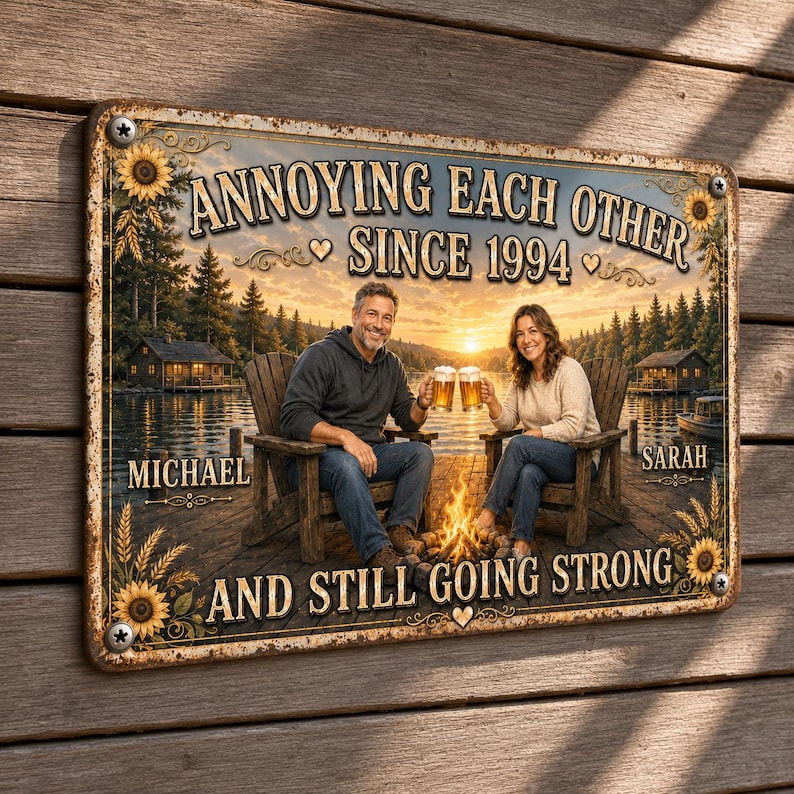 May include: A rectangular metal sign featuring a lake scene with a couple sitting in chairs by a fire, holding beer mugs. The text reads: ANNOYING EACH OTHER SINCE 1994, MICHAEL, SARAH, AND STILL GOING STRONG. The sign has a rustic, weathered border.