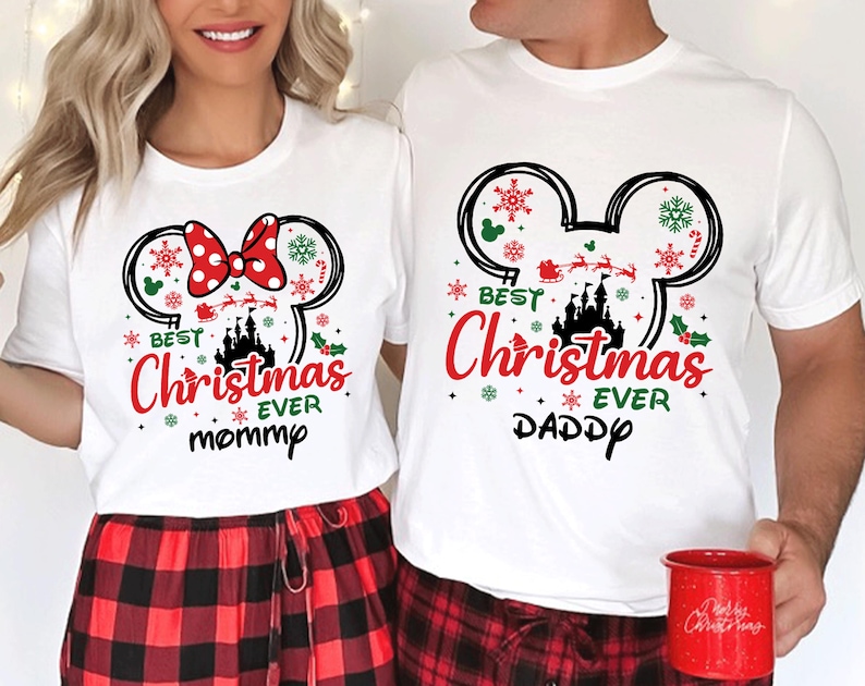 May include: Two white short-sleeve t-shirts featuring a black Mickey Mouse ear silhouette filled with red and green Christmas icons, a castle, and Santa's sleigh. The text reads "BEST Christmas EVER" with "mommy" on one shirt and "DADDY" on the other.