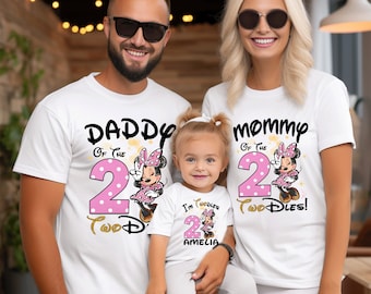 May include: Three white t-shirts featuring a Minnie Mouse graphic with pink polka dots and the number two. The shirts display the text Daddy of the 2 Two-dles, Mommy of the 2 Two-dles, and I'm Two-dles Amelia, with gold glitter accents.