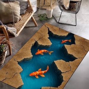 May include: A rectangular rug with a 3D design of a river and koi carp. The rug depicts a blue river with orange and white koi carp. The river is surrounded by brown, cracked rock formations, creating a visual depth.