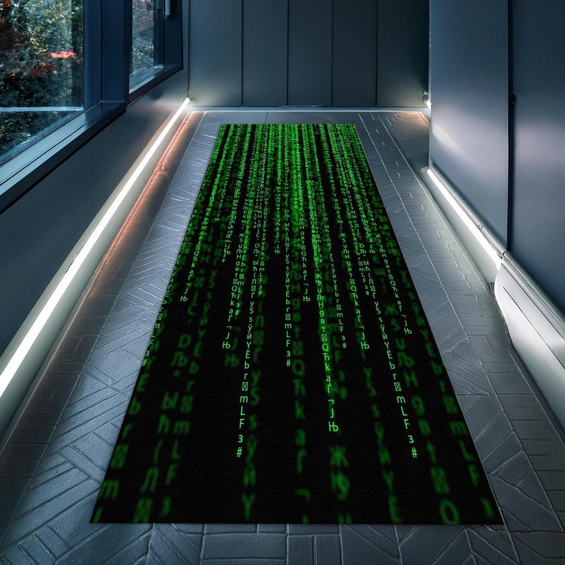 May include: A black and green rug with a repeating pattern of green code on a black background. The rug is laid out on a gray tiled floor.