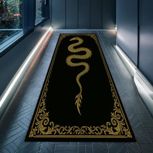May include: Black rectangular rug with a gold dragon design. The dragon is centrally placed, with a detailed gold border. The rug is in a hallway with a modern design. The rug's dimensions are not visible.