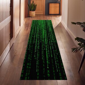 May include: A black and green runner rug with a pattern of green code cascading down the rug.
