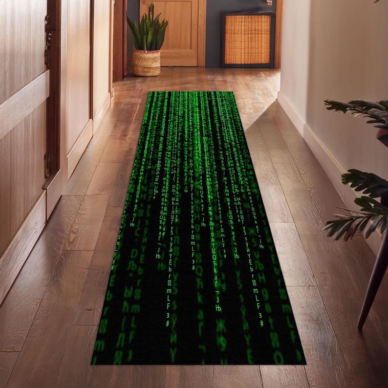 May include: A black and green runner rug with a pattern of green code cascading down the rug.