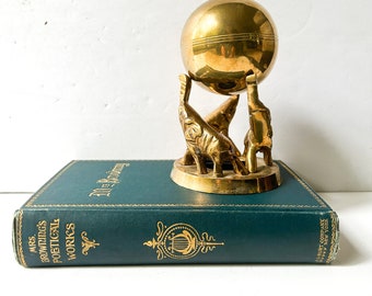 Vintage brass elephant stand with ball sphere