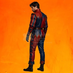 May include: A two-toned red and blue leather costume featuring a jacket with a pointed collar and long sleeves, paired with matching trousers. The garment displays a diamond pattern on the sleeves and legs, a brown belt, and black boots.