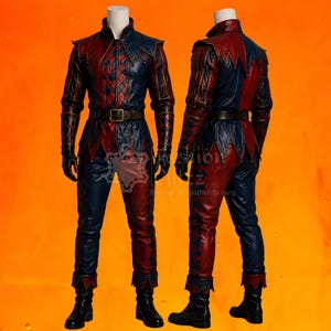 May include: A two-piece costume set featuring a long-sleeved jacket and trousers in a red and navy blue diamond pattern. The jacket has a high collar, pointed hem details, and a dark brown belt with a gold buckle. Black gloves and boots complete the look.