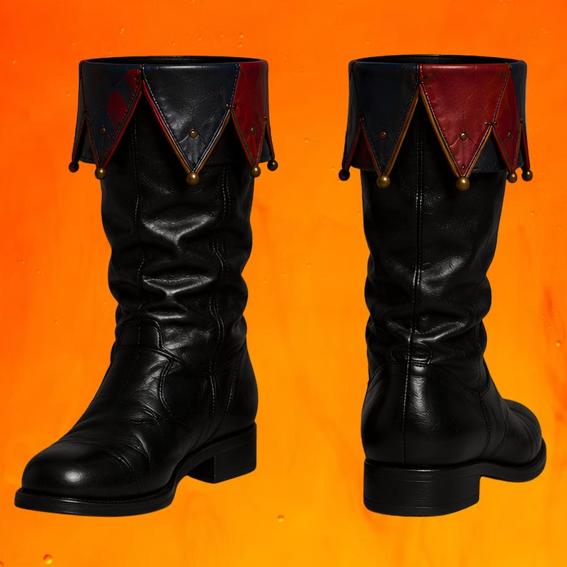 May include: A pair of black mid-calf boots featuring a decorative fold-over cuff. The cuff is designed with alternating dark blue and red triangular points, each accented with a small metallic bead at the tip, creating a distinct layered appearance.