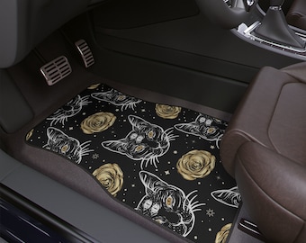 May include: Black car floor mats with a repeating pattern of gold roses and black cats with three eyes. The cats have a mystical, occult vibe.