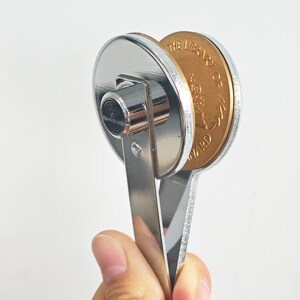 May include: A silver metal award stamp with a gold-colored round disc that reads "The Best Of Award".