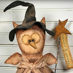 May include: A brown owl with a black witch hat and wings, holding a stick with a star and a banner that reads "Trick or Treat".