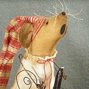 May include: A brown felt mouse wearing a red and white striped sleep cap and a white shirt with a red ribbon. The mouse is holding a fishing rod with a worm on the hook.