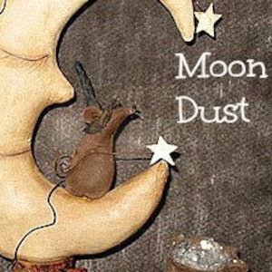 May include: A whimsical wooden sculpture of a crescent moon with a small mouse wearing a witch's hat perched on top. The mouse is holding a star-shaped stick. The moon has a face and is surrounded by stars. The text "Moon Dust" is written in white on a brown background.