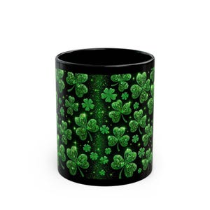 May include: Black ceramic mug with a green glitter shamrock pattern.